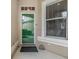 Inviting entryway featuring a glass paneled door, neutral exterior and convenient access for visitors to enter the home at 3205 Audubon Ct, Tarpon Springs, FL 34688