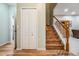 Foyer with wooden floors and staircase with white spindles and wooden handrail at 3205 Audubon Ct, Tarpon Springs, FL 34688