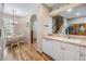 Open kitchen offering wood-look floors with a view of the dining area and a glimpse of the stairs with natural light at 3205 Audubon Ct, Tarpon Springs, FL 34688
