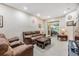 Bright and airy living room with tile flooring and access to the screened Florida room at 3205 Audubon Ct, Tarpon Springs, FL 34688