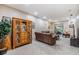 Relaxing living room featuring neutral tile flooring, comfortable sofas, and access to Florida room at 3205 Audubon Ct, Tarpon Springs, FL 34688
