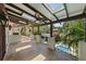 Spacious balcony featuring covered seating area with ceiling fans overlooking the pool and lush landscaping at 3212 W Fountain Blvd, Tampa, FL 33609