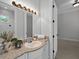Bathroom featuring a granite countertop, white sink and view to carpeted bedroom at 3212 W Fountain Blvd, Tampa, FL 33609