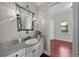 Bathroom showcasing a decorative mirror, stylish sconces, and granite counters with sink at 3212 W Fountain Blvd, Tampa, FL 33609