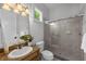 Bright bathroom features a sink with a granite countertop and a glass-enclosed shower at 3212 W Fountain Blvd, Tampa, FL 33609
