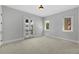 Bright bedroom featuring french doors and two bright windows with neutral carpet at 3212 W Fountain Blvd, Tampa, FL 33609