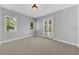 Bedroom featuring bright windows, neutral carpet and french doors at 3212 W Fountain Blvd, Tampa, FL 33609