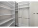 Walk-in closet featuring adjustable shelving and hanging rods at 3212 W Fountain Blvd, Tampa, FL 33609