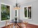 Dining room showcasing hardwood floors, natural light and table seating, overlooking the pool at 3212 W Fountain Blvd, Tampa, FL 33609
