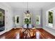 Dining room featuring hardwood floors, natural light and table seating, overlooking the pool at 3212 W Fountain Blvd, Tampa, FL 33609