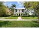 Two-story home with a manicured lawn and charming exterior with a tile roof and arched entryways at 3212 W Fountain Blvd, Tampa, FL 33609