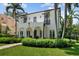 Charming two-story home with manicured lawn and an elegant facade with arched entryways at 3212 W Fountain Blvd, Tampa, FL 33609