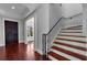 Grand foyer with elegant staircase, dark wood door and hardwood floors at 3212 W Fountain Blvd, Tampa, FL 33609