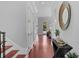 Hallway with wood floors, white trim and doors, leading to an open outdoor area at 3212 W Fountain Blvd, Tampa, FL 33609