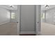 Neutral hallway featuring beige carpeting with access to dual, naturally-lit rooms at 3212 W Fountain Blvd, Tampa, FL 33609