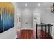 Bright hallway features hardwood floors, modern lighting, and decorative railings at 3212 W Fountain Blvd, Tampa, FL 33609