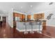 Kitchen with stainless steel appliances, dark countertops, wood cabinets, and island with bar stools at 3212 W Fountain Blvd, Tampa, FL 33609