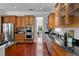 Kitchen featuring stainless steel appliances, wood cabinets, granite counters, and hardwood floors at 3212 W Fountain Blvd, Tampa, FL 33609