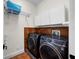 Well-organized laundry room with modern washer, dryer, and ample storage space at 3212 W Fountain Blvd, Tampa, FL 33609
