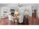 Well-lit living room featuring dark hardwood floors, a fireplace, and comfortable seating arrangements at 3212 W Fountain Blvd, Tampa, FL 33609