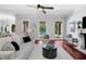 Open-concept living room with access to the pool, cozy seating, and wood floors at 3212 W Fountain Blvd, Tampa, FL 33609