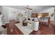 Bright living room with hardwood floors, white furniture, and an open floor plan to the kitchen at 3212 W Fountain Blvd, Tampa, FL 33609