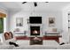Cozy living room with fireplace, TV, comfortable seating, and views of the outdoors at 3212 W Fountain Blvd, Tampa, FL 33609