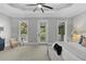 Large main bedroom with ceiling fan, three large windows and direct balcony access at 3212 W Fountain Blvd, Tampa, FL 33609