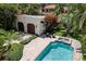Aerial view of the pool and guest house surrounded by tropical landscaping at 3212 W Fountain Blvd, Tampa, FL 33609