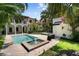 Backyard pool has a fountain, lush landscaping, and a patio perfect for entertaining at 3212 W Fountain Blvd, Tampa, FL 33609