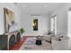 Bright sitting room with wood floors, art, modern furniture, and natural light from the windows at 3212 W Fountain Blvd, Tampa, FL 33609