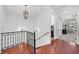 Upstairs landing with hardwood floors and wrought iron banister at 3212 W Fountain Blvd, Tampa, FL 33609
