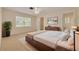 Spacious bedroom with a large window, a ceiling fan, and an ensuite bathroom at 3569 Oak Lake Dr, Palm Harbor, FL 34684