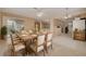 Inviting dining area with a large wooden table, comfortable seating, and seamless access to the kitchen at 3569 Oak Lake Dr, Palm Harbor, FL 34684