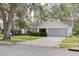 Inviting home features a well-maintained lawn, trimmed hedges, and a spacious two-car garage at 3569 Oak Lake Dr, Palm Harbor, FL 34684