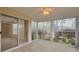 Bright sunroom with sliding glass doors and garden views at 3569 Oak Lake Dr, Palm Harbor, FL 34684