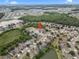 Expansive aerial shot of a community with mature trees, serene ponds, and well-maintained single-Gathering homes at 35819 Diamond Head Ct, Zephyrhills, FL 33541