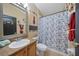 Bathroom with neutral walls featuring a vanity, mirror, and a shower with a decorative curtain at 35819 Diamond Head Ct, Zephyrhills, FL 33541