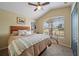 Bright bedroom with a large window, stylish headboard and cozy bedding for a comfortable retreat at 35819 Diamond Head Ct, Zephyrhills, FL 33541