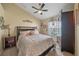 Charming bedroom with neutral-toned walls, ceiling fan, and an armoire for ample storage space at 35819 Diamond Head Ct, Zephyrhills, FL 33541