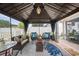 Outdoor gazebo featuring comfortable seating, decorative pillows, and a patterned rug at 35819 Diamond Head Ct, Zephyrhills, FL 33541
