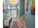 Tastefully decorated hallway featuring a beautiful console table, artwork, and a staircase at 35819 Diamond Head Ct, Zephyrhills, FL 33541