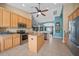 Modern kitchen with stainless steel appliances, granite countertops, tile floor, and center island at 35819 Diamond Head Ct, Zephyrhills, FL 33541