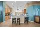 Bright kitchen featuring counter seating, neutral tiling, stainless steel appliances, and a ceiling fan at 35819 Diamond Head Ct, Zephyrhills, FL 33541
