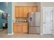 Bright kitchen area showcases a stainless steel refrigerator, cabinets, and a pantry at 35819 Diamond Head Ct, Zephyrhills, FL 33541