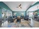 Spacious living room with blue walls, large area rug, ceiling fan, and comfortable seating at 35819 Diamond Head Ct, Zephyrhills, FL 33541