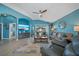 Cozy living room featuring stylish decor, blue walls, and sliding glass door to the lanai at 35819 Diamond Head Ct, Zephyrhills, FL 33541