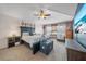 Serene main bedroom featuring tray ceilings, soothing colors, and comfortable seating area at 35819 Diamond Head Ct, Zephyrhills, FL 33541