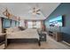 Spacious main bedroom featuring a tray ceiling, soothing colors, and flat screen TV at 35819 Diamond Head Ct, Zephyrhills, FL 33541