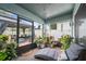 Relaxing screened patio with comfortable lounge chair, potted plants and exterior gazebo at 35819 Diamond Head Ct, Zephyrhills, FL 33541
